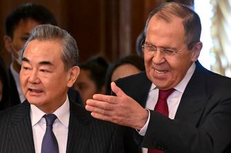 epa10483095 Russian Foreign Minister Sergei Lavrov (R) and China's Director of the Office of the Central Foreign Affairs Commission Wang Yi (L) enter a hall during a meeting in Moscow, Russia, 22 February 2023. Wang Yi arrived in Moscow on 21 February, and engaged in negotiations with the Secretary of the Security Council of the Russian Federation Nikolai Patrushev. At this meeting, Wang Yi stressed that Chinese-Russian relations are 'strong as a rock' and 'will stand the test in the changing international situation.' According to Wang Yi, Beijing is ready, together with Moscow, to resolutely defend national interests and promote mutually beneficial cooperation in all areas.  EPA/ALEXANDER NEMENOV / POOL