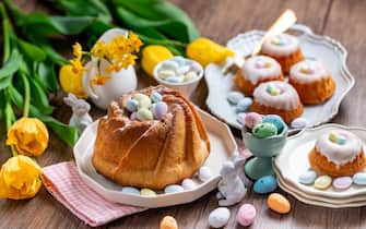 Easter yeast cake sprinkled with powdered sugar, decorated with chocolate eggs. Traditional Easter cake