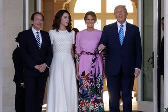 PALM BEACH, FLORIDA - APRIL 06: Republican presidential candidate and former US President Donald Trump (R) and former first lady Melania Trump (2nd-R) arrive at the home of John (L) and Jenny Paulson (2nd-L) on April 6, 2024 in Palm Beach, Florida. Trump's campaign is expecting to raise more than 40 million dollars, when major donors gather for a fundraiser billed as the "Inaugural Leadership Dinner". (Photo by Alon Skuy/Getty Images)