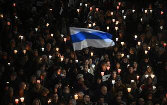 People hold candles during a vigil in honor of Kremlin's critic Alexei Navalny following is death, on February 19, 2024 in front of Rome's city hall. Russia reported Navalny's death in an arctic prison on February 16, 2024 and his mother has been denied access to the body, enraging supporters who have accused authorities of trying to cover up Navalny's "murder". (Photo by Filippo MONTEFORTE / AFP) (Photo by FILIPPO MONTEFORTE/AFP via Getty Images)