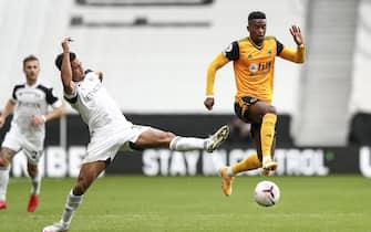 epa08719914 Antonee Robinson of Fulham (L) and Nelson Semedo of Wolverhampton Wanderers (R) in action during the English Premier League match between Wolverhampton Wanderers and Fulham in Wolverhampton, Britain, 04 October 2020.  EPA/Jan Kruger / POOL EDITORIAL USE ONLY. No use with unauthorized audio, video, data, fixture lists, club/league logos or 'live' services. Online in-match use limited to 120 images, no video emulation. No use in betting, games or single club/league/player publications.