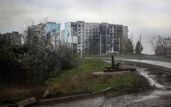 EDITORS NOTE: Graphic content / (FILES) This photograph taken on April 23, 2023, through a bulletproof car glass shows residential buildings damaged by shelling in the frontline city of Bakhmut, Donetsk region, on April 23, 2023, amid the Russian invasion of Ukraine. Russia's private army Wagner claimed on May 20, 2023, the total control of the east Ukrainian city of Bakhmut, the epicentre of fighting, as Kyiv said the battle was continuing but admitted the situation was "critical". Bakhmut, a salt mining town that once had a population of 70,000 people, has been the scene of the longest and bloodiest battle in Moscow's more than year-long Ukraine offensive. The fall to Russia of Bakhmut, where both Moscow and Kyiv are believed to have suffered huge losses, would have high symbolic value. (Photo by Anatolii Stepanov / AFP)