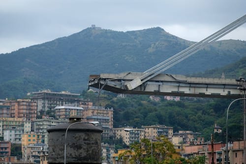 A picture taken on August 14, 2018 in Genoa shows a view of the Ponte Morandi motorway bridge, after one of its section collapsed injuring several people. - Rescuers scouring through the wreckage after part of a viaduct of the A10 freeway collapsed said there were "tens of victims", while images from the scene showed an entire carriageway plunged on to railway lines below. (Photo by ANDREA LEONI / AFP)        (Photo credit should read ANDREA LEONI/AFP via Getty Images)