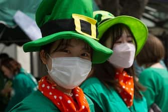 TOKYO, JAPAN - 2023/03/12: Japanese women dressed in leprechaun hats attend the 28th Saint Patrick's Day parade in Omotesando, Tokyo. The parade is the largest and oldest St Patrick's Day event in Asia and returned this year after a 3 year hiatus caused by the Coronavirus. It was apart of a two day "I love Ireland" festival with food, music and other cultural events in nearby Yoyogi park. (Photo by Damon Coulter/SOPA Images/LightRocket via Getty Images)