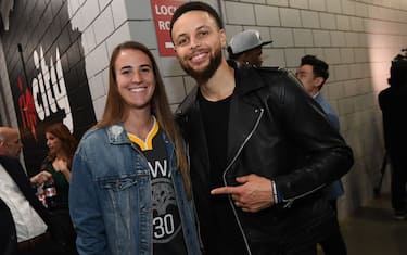 PORTLAND, OR - MAY 20: Stephen Curry #30 of the Golden State Warriors poses for a photo with Oregon Ducks Basketball player, Sabrina Ionescu, after advancing to the NBA Finals against the Portland Trail Blazers during Game Four of the Western Conference Finals on May 20, 2019 at the Moda Center in Portland, Oregon. NOTE TO USER: User expressly acknowledges and agrees that, by downloading and/or using this photograph, user is consenting to the terms and conditions of the Getty Images License Agreement. Mandatory Copyright Notice: Copyright 2019 NBAE (Photo by Noah Graham/NBAE via Getty Images)