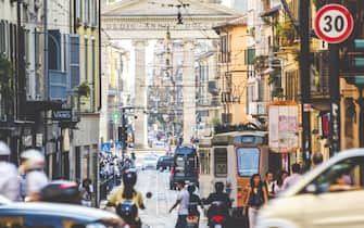 Evening time in busy streets of Milan, Italy.