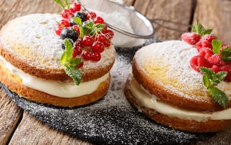 Mini sandwich cake with black and red currant, raspberry and mint closeup on table. horizontal
