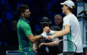 Serbia's Novak Djokovic (L) and Italy's Jannik Sinner shake hands after Sinner won their round-robin match against Serbia's Novak Djokovic on day 3 of the ATP Finals tennis tournament in Turin on November 14, 2023. (Photo by Tiziana FABI / AFP) (Photo by TIZIANA FABI/AFP via Getty Images)