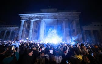 epa11254030 Participants hold up their smartphones at midnight with the beginning of the new day down in front of the Brandenburg Gate on the occasion of a so called 'Smoke-In' event in Berlin, Germany, 01 April 2024. Activists and supporters welcomed a new status of law, regarding the use of cannabis, in Germany. The German Federal Council 'Bundesrat' on 22 March approved a law decriminalizing the recreational usage of cannabis in Germany for adults age 18 and over. Starting 01 April 2024 it will be legal for adults in Germany to possess up to 50 grams of dried cannabis at home and up to 25 grams in public for personal use. The law allows growth and distribution only in cultivation associations also called Cannabis Social Clubs and comes into force on 01 July 2024. People can purchase cannabis for recreational use if they are members of those specific clubs but cannot consume it in the premises.  EPA/CLEMENS BILAN