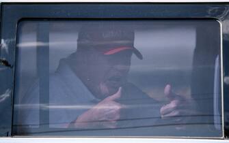TOPSHOT - Former US President Donald Trump sits in the rear of his limousine as he departs Trump International Golf Club in West Palm Beach, Florida, on April 1, 2023. - Trump is expected to surrender to the authorities in New York on April 4, 2023 to face charges over a hush-money payment to porn star Stormy Daniels. (Photo by CHANDAN KHANNA / AFP)