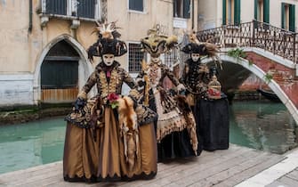 VENICE, ITALY - FEBRUARY 08:  People wearing carnival costumes pose on February 8, 2018 in Venice, Italy. The theme for the 2018 edition of Venice Carnival is 'Playing' and will run from 27 January to 13 February.  (Photo by Awakening/Getty Images)