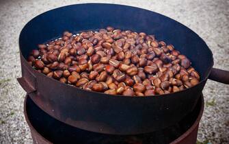 Roasted chestnuts. Cooking chestnuts. Italy. Europe.