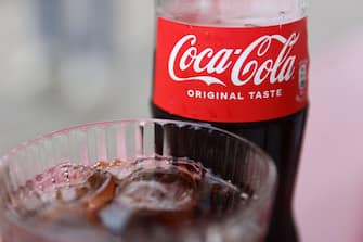 Coca-Cola bottle and glass are seen in this illustration photo taken in Milan, Italy on May 20, 2024. (Photo by Jakub Porzycki/NurPhoto via Getty Images)