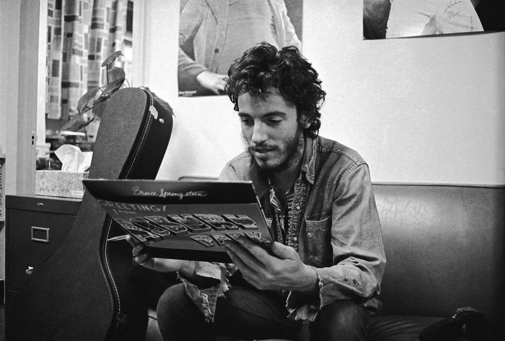 Bruce Springsteen in 1972, getting his first glimpse of his first album “Greetings from Asbury Park, NJ”. Programme title: Bruce Springsteen In His Own Words. Copyright: Art Maillet 1972