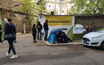 Alcuni studenti dentro una tenda da campeggio hanno montato dei cartelli di protesta contro il caro affitt  davanti al Miur a Roma, 11 maggio 2023.
ANSA/Cecilia Ferrara