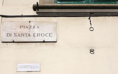Florence, ITALY:  Picture taken 27 October 2006 of the mark of the maximum level reached by the flood in Piazza Di Santa Croce in Florence after the flood on 04 November 1966. The floodwaters from the Arno River swept through the city and killed 87 people and poured tonnes of mud into museums and churches. Art restorers have appealed for money to rescue hundreds of works still caked in mud from floods in Florence 40 years ago. AFP PHOTO / ALBERTO PIZZOLI  (Photo credit should read ALBERTO PIZZOLI/AFP via Getty Images)