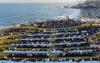 epa11998625 A picture taken with a drone shows Israeli Arabs attending prayers during the Muslim holiday of Eid al-Fitr in a park at the Jaffa beach in Tel Aviv, Israel, 30 March 2025. Eid al-Fitr, one of Islam's two major holidays, marks the end of the holy month of Ramadan, and is celebrated during the first three days of Shawwal, the 10th month of the Islamic calendar.  EPA/ABIR SULTAN