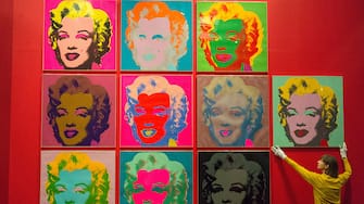 LONDON, UNITED KINGDOM - FEBRUARY 10:  Museum staff makes final adjustments to a selection of ten colour Andy Warhol screen prints featuring Marilyn Monroe installed in the British Museums Sainsburys exhibition gallery in London, United Kingdom on February 10, 2017. The prints are part of the museums Spring headline exhibition The American Dream: Pop to the present.





  (Photo by Ray Tang/Anadolu Agency/Getty Images)