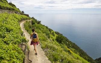A woman hiking the Cinque Terre, Italy