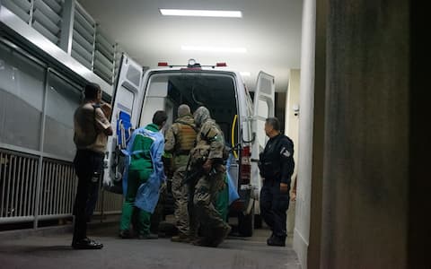 RIO DE JANEIRO, BRAZIL  OCTOBER 28: A wounded military police officer is transferred into an ambulance at Getulio Vargas Hospital following a large-scale security operation targeting the Comando Vermelho (CV) gang in the Alemao and Penha complexes in the northern zone of Rio de Janeiro, Brazil, on October 28, 2025. At least 64 people  including four police officers  were killed and 81 suspects were detained in what officials describe as the deadliest police operation in the state's history. (Photo by Fabio Teixeira/Anadolu via Getty Images)