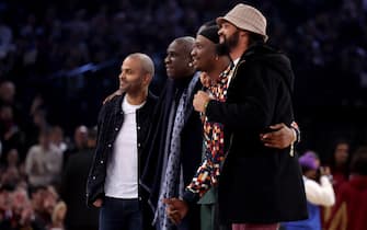 French basketball legends (from L) Tony Parker, Mickael Pietrus, Kevin Seraphin and Joakim Noah pose during a time out of the NBA regular season basketball match between the Cleveland Cavaliers and the Brooklyn Nets at the Accor Arena in Paris on January 11, 2024. (Photo by Emmanuel Dunand / AFP)