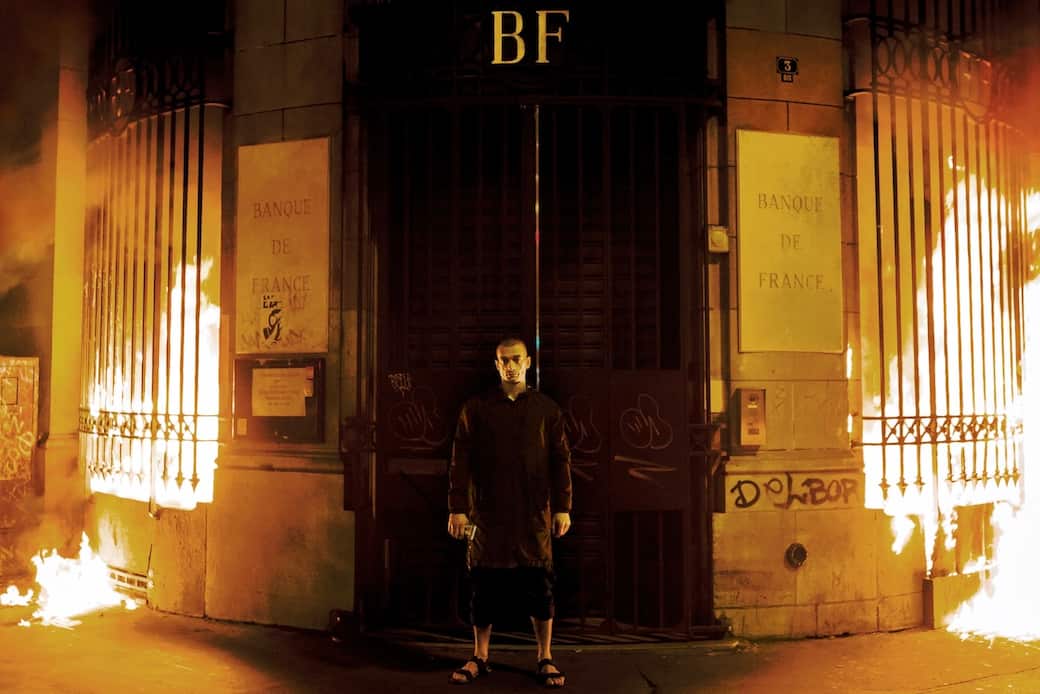 LIGHTING: In October 2017, in Paris, Pavlensky set fire to two windows of the Bank of France. © AP Photo/Capucine Henry. Image courtesy of Pyotr Pavlensky