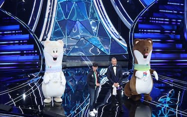 SANREMO, ITALY - FEBRUARY 07: The mascots of the Milan-Cortina 2026 Winter Olympics and Paralympics, Federico Barra and Amadeus attend the 74th Sanremo Music Festival 2024 at Teatro Ariston on February 07, 2024 in Sanremo, Italy. (Photo by Daniele Venturelli/Daniele Venturelli/Getty Images )