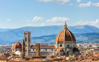 View of the Duomo Santa Maria del Fiore cathedral and Bell Tower of Giotto in Florence, Italy in a colorful sunset, aerial view