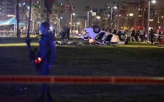 epa10564158 Israeli policemen work at the scene of a shooting and ramming attack in Tel Aviv, Israel, 07 April 2023. According to Israeli police, one tourist was shot and killed and five others were injured when a driver rammed his car into passers-by on the beach promenade of Tel Aviv.  EPA/ABIR SULTAN