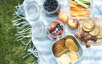 A homemade picnic with fresh organic healthy food in plastic free reusable containers.