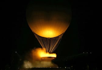 The cauldron, with the Olympic flame lit, lifts off while attached to a balloon during the opening ceremony of the Paris 2024 Olympic Games in Paris on July 26, 2024. (Photo by Ben STANSALL / AFP) (Photo by BEN STANSALL/AFP via Getty Images)