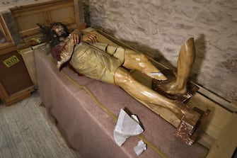 A picture shows a wooden statue of Jesus that was pulled down and damaged in the Church of the Condemnation, where Christians believe Jesus was flogged and sentenced to death, in Jerusalem's Old City on February 2, 2023. - Israeli police said officers arrested an American man today over vandalising the church along a major pilgrimage route in Jerusalem's Old City. "The suspect arrested is an American tourist in his forties, who vandalised and broke a statue in the church," said a statement from the Israeli police, adding that the man's mental health was being assessed. A spokeswoman for the United States embassy in Jerusalem did not comment on the incident when contacted by AFP. (Photo by AHMAD GHARABLI / AFP) (Photo by AHMAD GHARABLI/AFP via Getty Images)