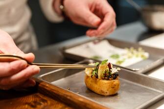 Clare Smyth, chef, prepares a dish of 'Potato and Roe' at the Core by Clare Smyth restaurant in the Notting Hill district of London, U.K., on Wednesday, Jan. 16, 2019. Smyth has worked under Alain Ducasse at the three-Michelin-star Louis XV in Monaco and was the guardian of Gordon Ramsay's three stars for almost a decade, the first woman ever to hold three stars in the U.K. Photographer: Miles Willis/Bloomberg via Getty Images