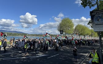 GENEVA, SWITZERLAND - APRIL 20: People gather to stage Pro-Palestinian protest and demand immediate and permanent ceasefire for Gaza in Geneva, Switzerland on April 20, 2024. Crowds congregated at Place de Neuve Square and embarked on amarch through the city center. Protesters vocalized chants denouncing Israel while brandishing Palestinian flags and placards displaying messages of solidarity with the Palestinians. Demonstrators demanded an urgent and enduring ceasefire. (Photo by Muhammet Ikbal Arslan/Anadolu via Getty Images)