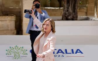 Italy's Prime Minister Giorgia Meloni takes a selfie with a mobile telephone upon arrival at the Borgo Egnazia resort for the G7 Summit hosted by Italy in Apulia region, on June 13, 2024 in Savelletri. Leaders of the G7 wealthy nations gather in southern Italy this week against the backdrop of global and political turmoil, with boosting support for Ukraine top of the agenda. (Photo by Ludovic MARIN / AFP)