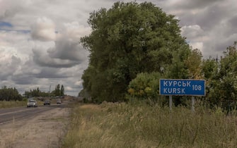 TOPSHOT - This photograph shows Ukrainian military vehicles driving past the border crossing point with Russia, in the Sumy region, on August 13, 2024, amid the Russian invasion of Ukraine. On August 6, 2024, Ukraine launched an offensive surprise into the Russian border region of Kursk capturing over two dozen towns and villages in the most significant cross-border attack on Russian territory since World War II. Ukraine's military chief Oleksandr Syrsky told the Ukrainian President in a video posted on August 12, 2024 that his troops now control about 1,000 square kilometres of Russian territory and are continuing "offensive operations". (Photo by Roman PILIPEY / AFP)