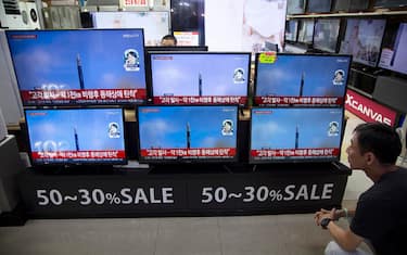 epa10740721 A man watches the news on TV screens at Yongsan Electronic Land in Seoul, South Korea, 12 July 2023. According to South Korea's Joint Chiefs of Staff (JCS), North Korea launched an Intercontinental Ballistic Missile (ICBM) into the East Sea.  EPA/JEON HEON-KYUN