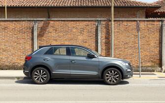 Udine, Italy. May 31, 2023. Gray Volkswagen T-Roc, subcompact suv of the german automaker, with brick wall on background Side view.