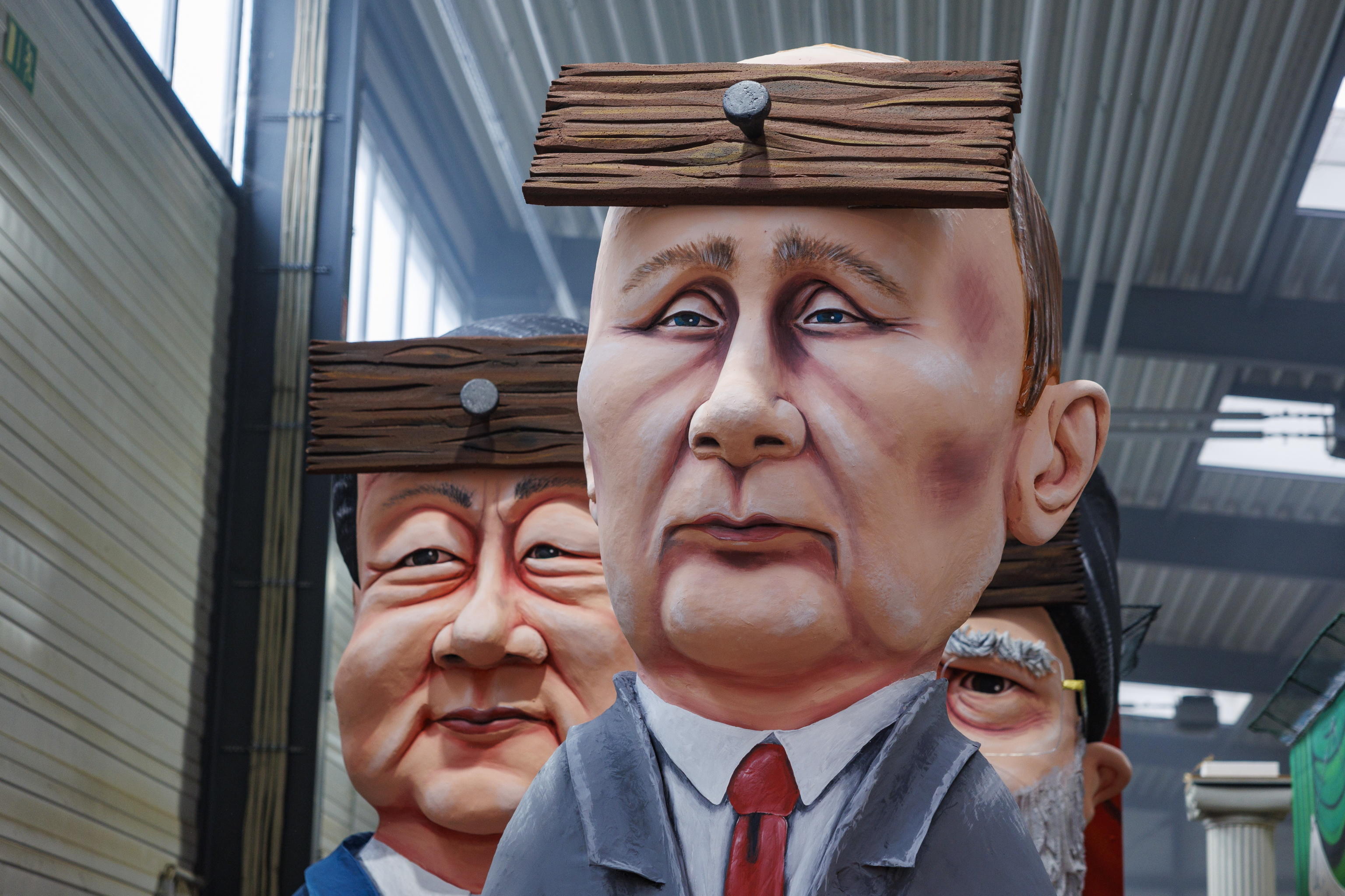 epa11131390 A carnival float depicts Russian President Vladimir Putin (C), China's President Xi Jinping (L), and Iranian Supreme Leader Ayatollah Ali Khamenei (partly hidden) during the presentation of the floats for the annual Rose Monday parade in Cologne, Germany, 06 February 2024. Rose Monday is the traditional highlight of the carnival season in many German cities.  EPA/CHRISTOPHER NEUNDORF