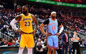 ATLANTA, GA - FEBRUARY 12: LeBron James #23 of the Los Angeles Lakers, and Vince Carter #15 of the Atlanta Hawks looks on during the game on February 12, 2019 at State Farm Arena in Atlanta, Georgia.  NOTE TO USER: User expressly acknowledges and agrees that, by downloading and/or using this Photograph, user is consenting to the terms and conditions of the Getty Images License Agreement. Mandatory Copyright Notice: Copyright 2019 NBAE (Photo by Scott Cunningham/NBAE via Getty Images)