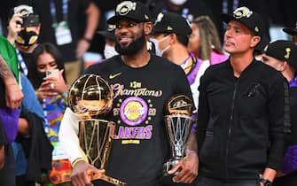 ORLANDO, FL - OCTOBER 11: LeBron James #23 of the Los Angeles Lakers celebrates after receiving the Bill Russell Finals MVP Trophy and the Larry O'Brien Trophy after Game Six of the NBA Finals on October 11, 2020 at the AdventHealth Arena at ESPN Wide World Of Sports Complex in Orlando, Florida. NOTE TO USER: User expressly acknowledges and agrees that, by downloading and/or using this Photograph, user is consenting to the terms and conditions of the Getty Images License Agreement. Mandatory Copyright Notice: Copyright 2020 NBAE (Photo by Garrett Ellwood/NBAE via Getty Images)