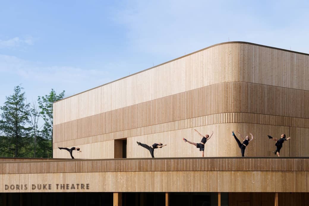 Doris Duke Theatre on the Jacob’s Pillow campus. BOCATUYA dancers on the roof above west entrance. Copyright Iwan Baan; Courtesy of Jacob’s Pillow