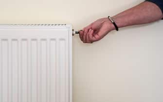 Bleeding a radiator valve to release any trapped air and ensure the central heating system is running efficiently.