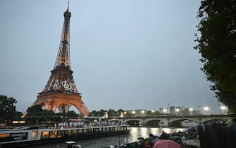 The delegations from Niger, Nigeria and Norway sail in a boat along the river Seine during the opening ceremony of the Paris 2024 Olympic Games in Paris on July 26, 2024, as the Eiffel Tower is seen in the background. (Photo by Paul ELLIS / AFP) (Photo by PAUL ELLIS/AFP via Getty Images)