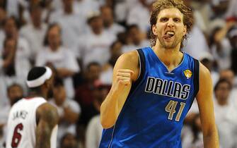 Dirk Nowitzki of the Dallas Mavericks celebrates a point against the Miami Heat in Game 6 of  the NBA Finals on June 12, 2011 at the AmericanAirlines Arena in Miami, Florida.  Jason Terry scored 27 points and Nowitzki finished with 21 points and 11 rebounds as the Mavericks won 105-95 to take the best-of-seven championship series four-games-to-two to claim their first NBA championship in franchise history. AFP PHOTO / Don EMMERT (Photo credit should read DON EMMERT/AFP via Getty Images)