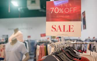 sale 70% off mock up advertise display frame setting over the clothes line in the shopping department store for shopping.