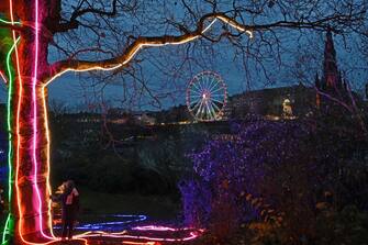 EDINBURGH, SCOTLAND  - NOVEMBER 21: A young girl looks out over the illuminations in Princes Street Gardens to the big wheel on Princes Street, as Edinburgh's Christmas and Hogmanay festivals get under way, on November 21, 2023, in Edinburgh, Scotland. (Photo by Ken Jack/Getty Images)