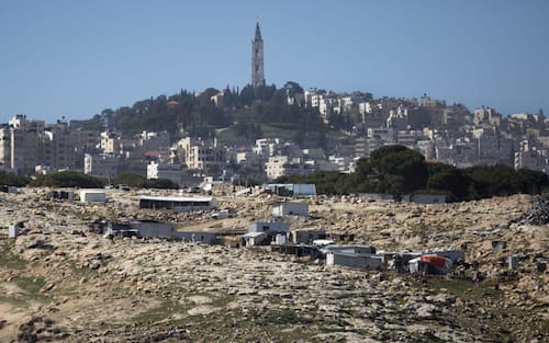 epa05776039 A view of Bedouin houses in the area known as E1 with East Jerusalem (behind), viewed from the Israeli settlement of Ma'ale Adumim, in the West Bank, 07 February 2017. The European Union's Foreign Affairs Council has postponed a meeting with Israeli diplomats, which was scheduled for the end of February, after Israel's passage of a law on 06 February 2017, dubbed the 'regularisation bill'. The law retroactively legalizes several thousand homes built illegally on private Palestinian land and accelerates Israeli construction in West Bank settlements and in East Jerusalem.  EPA/JIM HOLLANDER