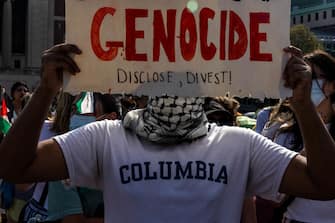 NEW YORK, NEW YORK - APRIL 29: A demonstrator protests outside the encampment established in support of Palestinians in Gaza at Columbia University on April 29, 2024 in New York City. Pro-Palestinian demonstrators marched as a 2 p.m. deadline to clear the encampment given to students by the university came and went. The students were given a suspension warning if they did not meet the deadline. Students at Columbia were the first from an elite college to erect an encampment, demanding that the school divest from Israel amid the Israel-Hamas war, in which more than 34,000 Palestinians have been killed in the Gaza Strip.  (Photo by Alex Kent/Getty Images) This happened hours after protestors were told to voluntarily disperse from the area or face suspensions.