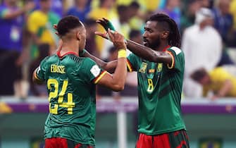 epa10345350 Cameroonian players Enzo Ebosse (L) and Andre-Frank Zambo Anguissa (R) react after winning the FIFA World Cup 2022 group G soccer match between Cameroon and Brazil at Lusail Stadium in Lusail, Qatar, 02 December 2022.  EPA/Abedin Taherkenareh